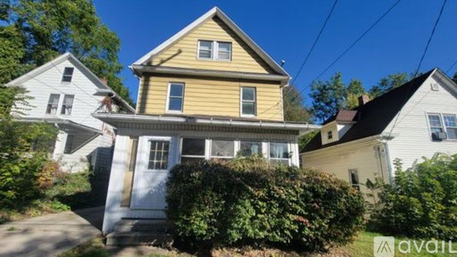 A house with a yellow front and a sign that says "available".