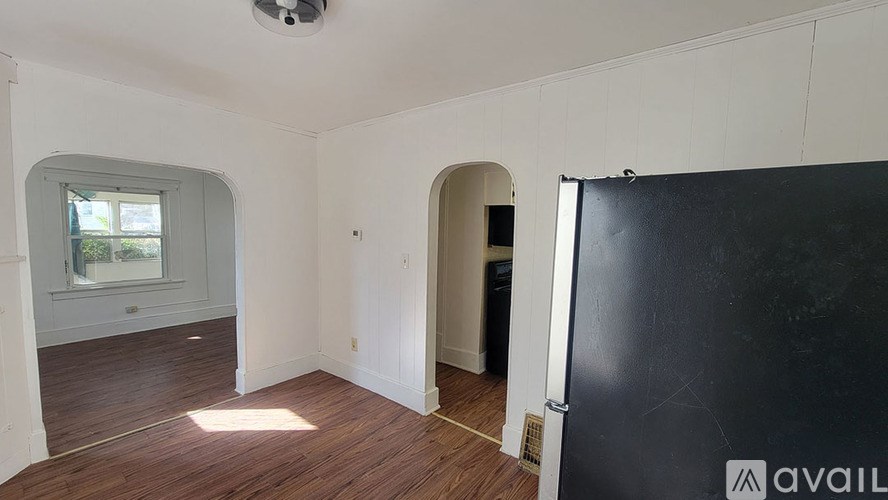 A room with wooden floors and a large window.