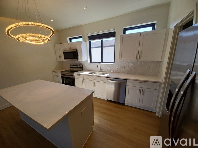 A kitchen with a white island in the middle.