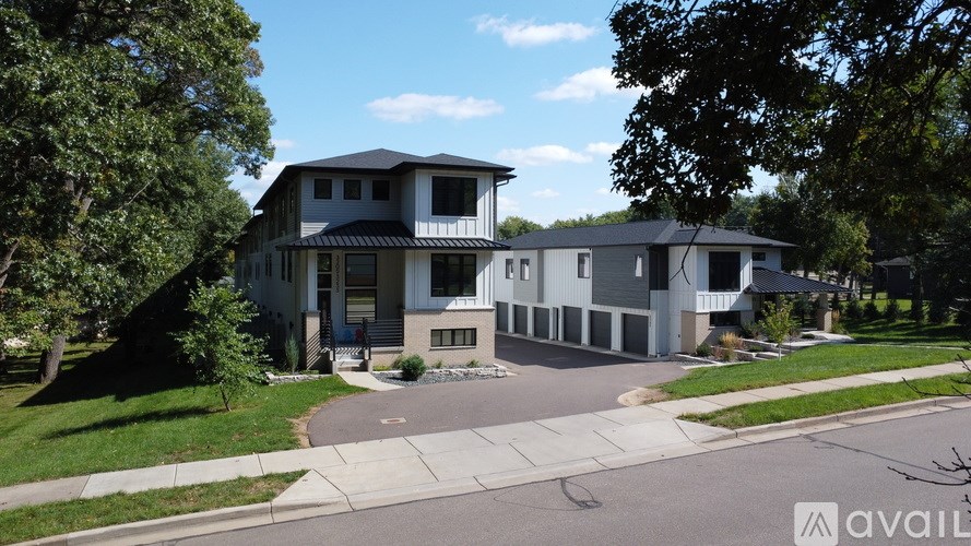 A modern house with a large front yard is available for purchase.