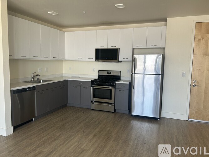 A kitchen with white cabinets and stainless steel appliances.