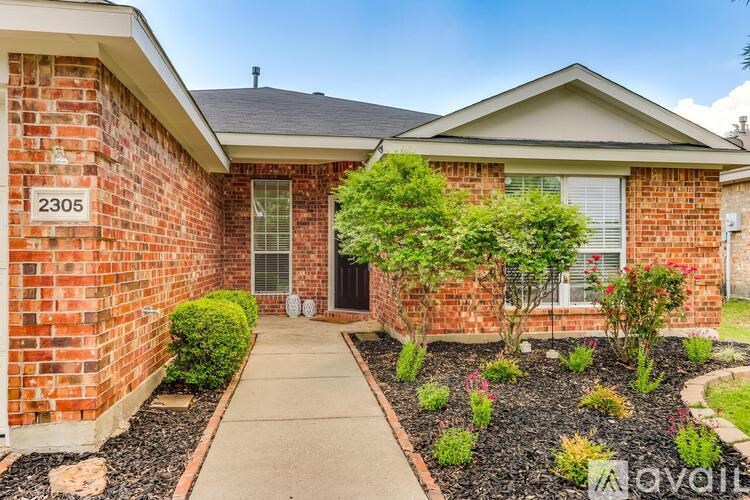 A brick house with the number 2305 on the front door.