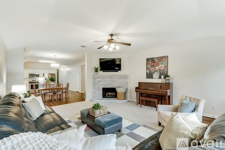 A living room with a fireplace and a television.