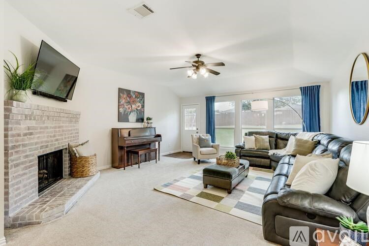 A living room with a fireplace, a couch, and a television.