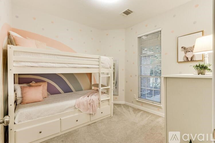 A bedroom with a bunk bed and a window with blinds.
