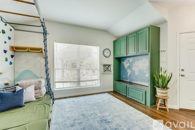 A room with a green bed and a blue rug.