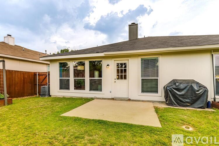 A house with a white exterior and a covered patio.