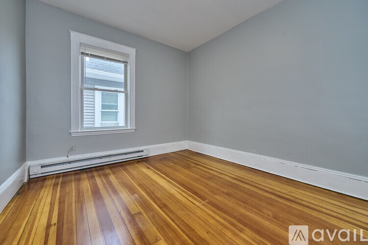 A room with wooden floors and a window.