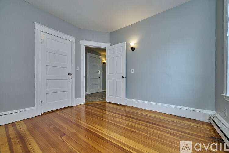 A room with wooden floors and white doors.