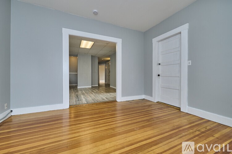 A room with wooden floors and a white door.