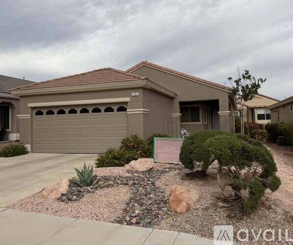 A house with a brown roof and a garage door is for sale.