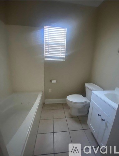 A bathroom with a toilet, sink, and bathtub.