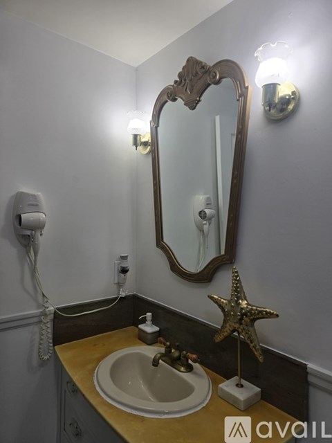 A bathroom with a sink, mirror, and a star decoration.