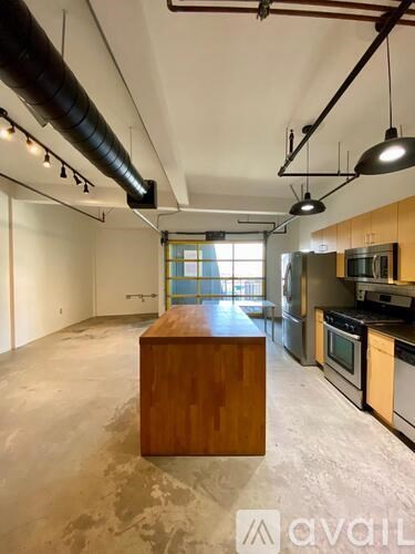A kitchen with a wooden island in the middle of the room.