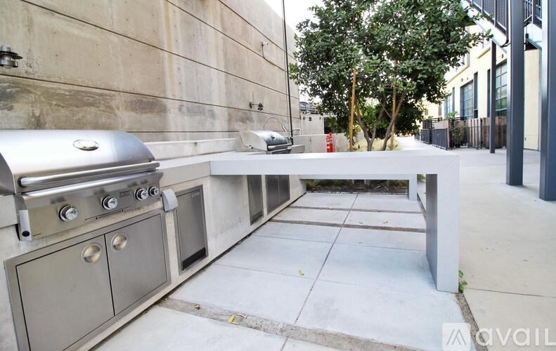 A stainless steel outdoor grill is on a patio.