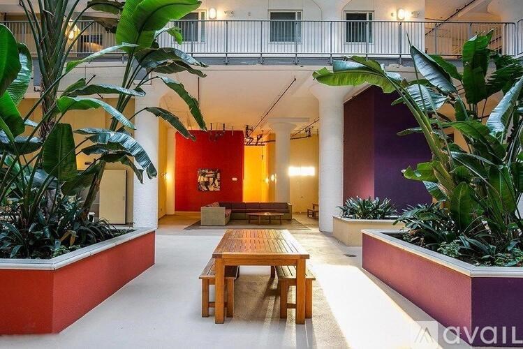 A room with a red wall and a wooden bench.