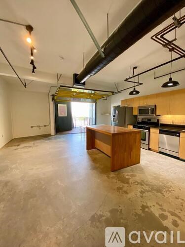 A large open space with a kitchen area in the background.