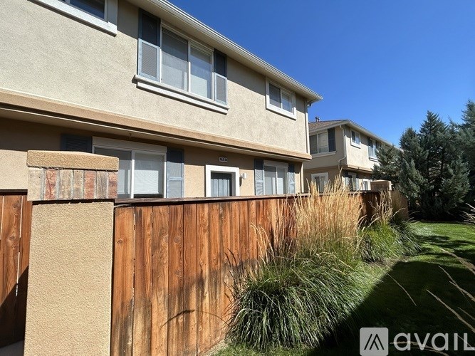A row of houses with a fence in front.