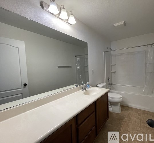 A bathroom with a sink, toilet, and bathtub.