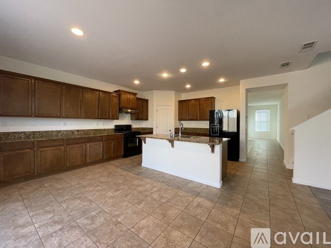A kitchen with brown cabinets and a white island.