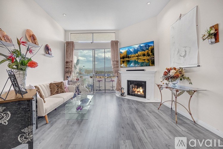 A living room with a fireplace and a large window.