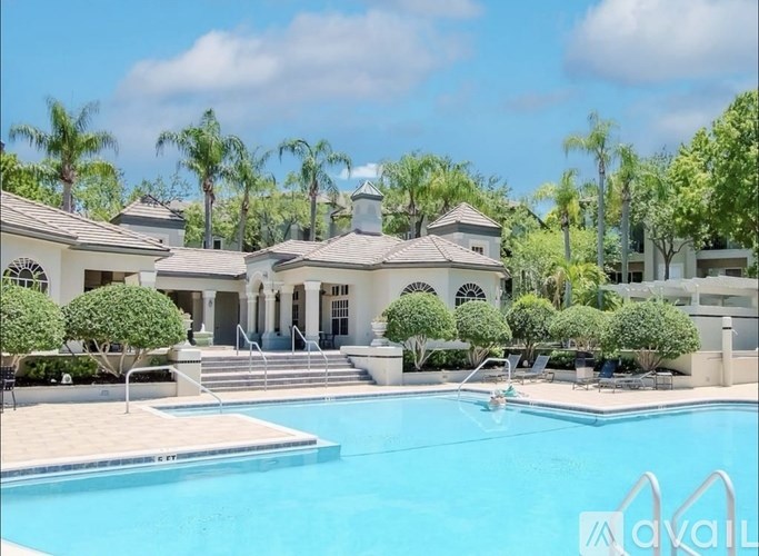 A large house with a pool in front of it.