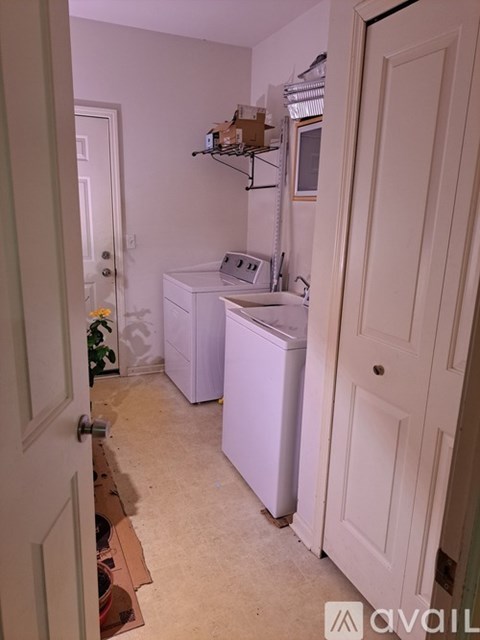 A small laundry room with a washer and dryer.