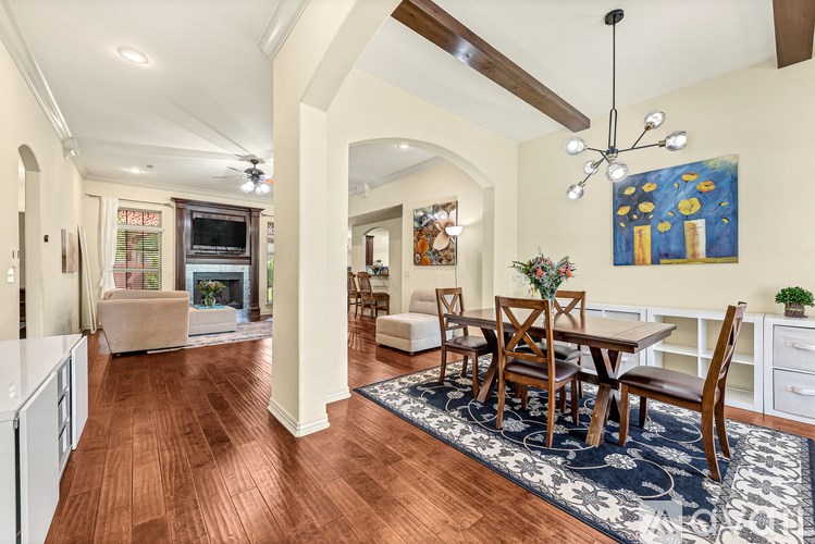 A dining room with a wooden table and chairs.