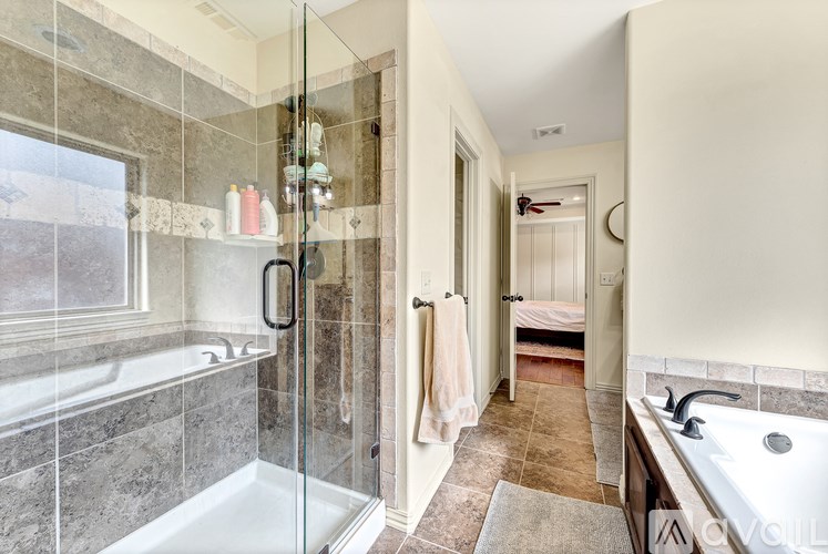A bathroom with a walk-in shower and a sink.