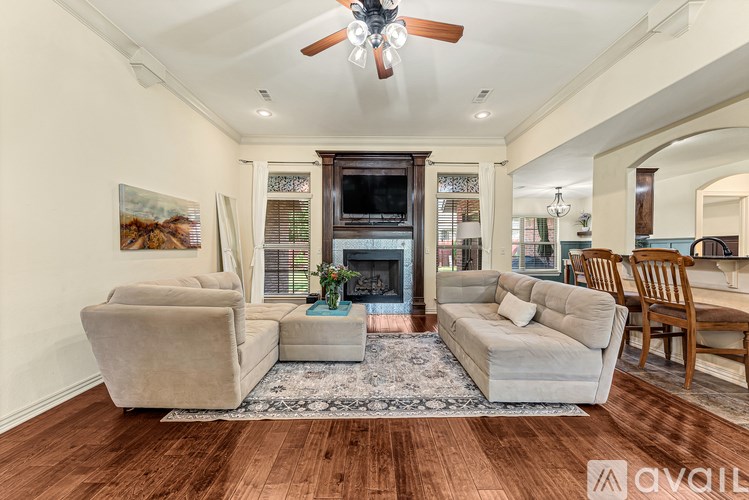 A living room with a fireplace and a painting on the wall.