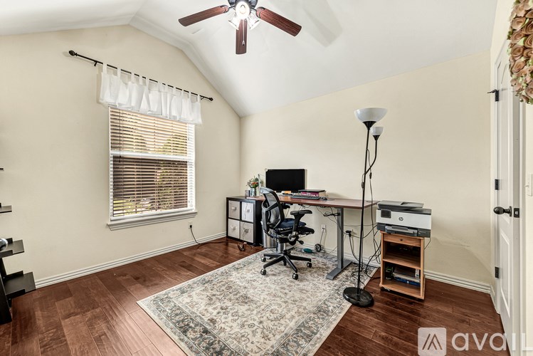 A room with a desk and a computer on it.