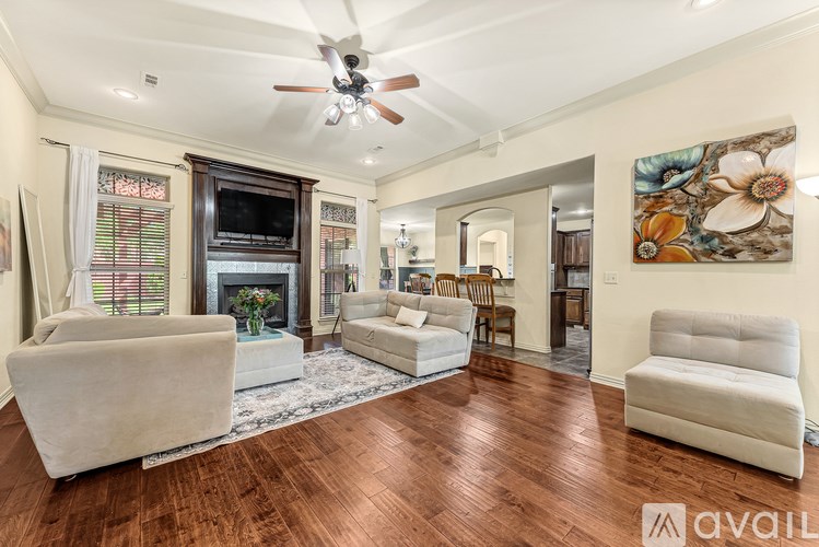 A living room with a fireplace and a painting on the wall.