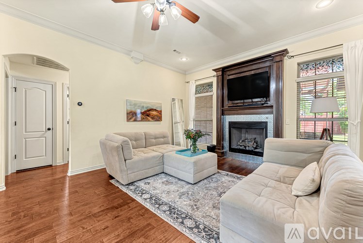 A living room with a fireplace and a television.