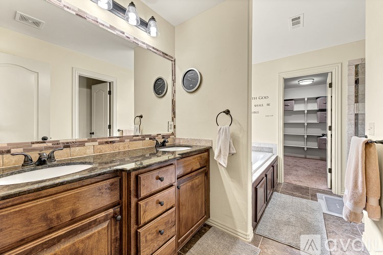 A bathroom with a vanity and a mirror.