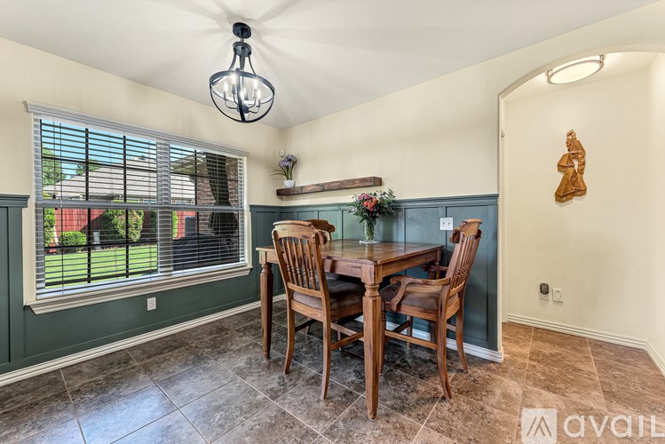 A dining room with a table and chairs.