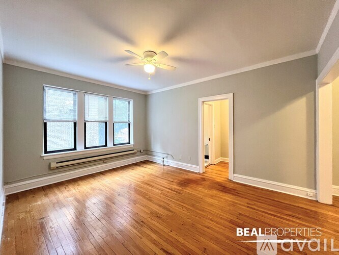 A room with wooden floors and a ceiling fan.