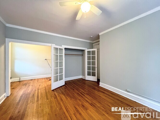 A room with a wooden floor and a ceiling fan.