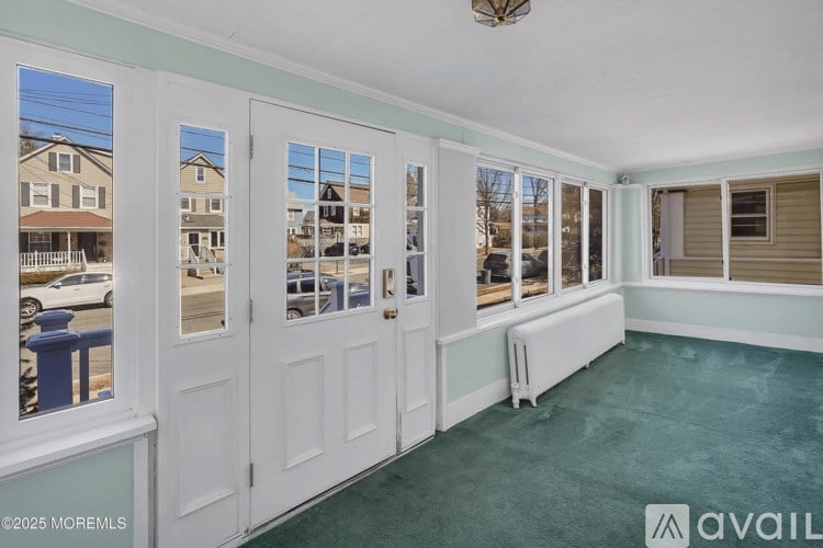 A room with a view of other houses through the windows.