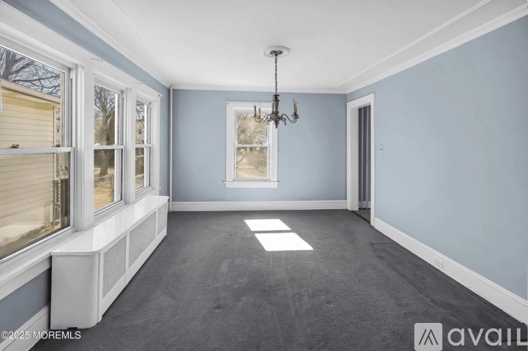 A room with blue walls and a chandelier.