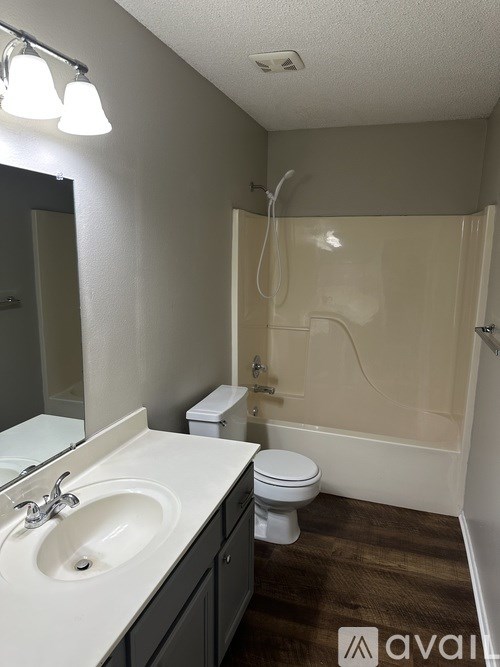 A bathroom with a toilet, sink, and shower.