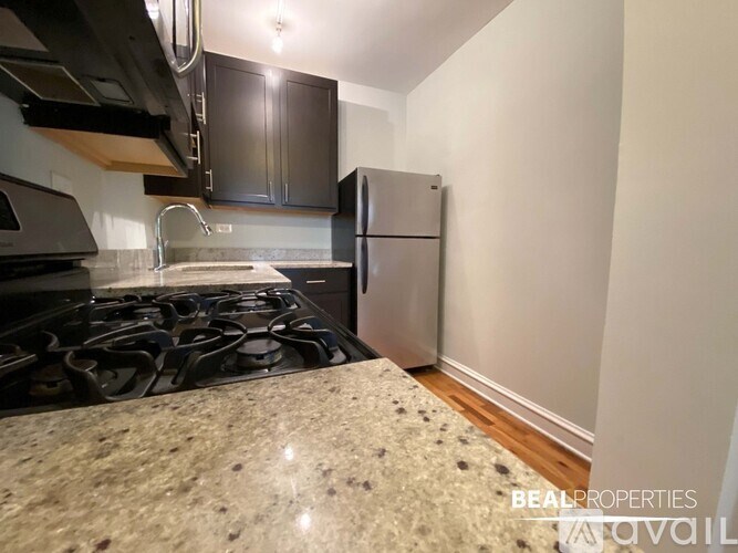 A kitchen with granite countertops and stainless steel appliances.