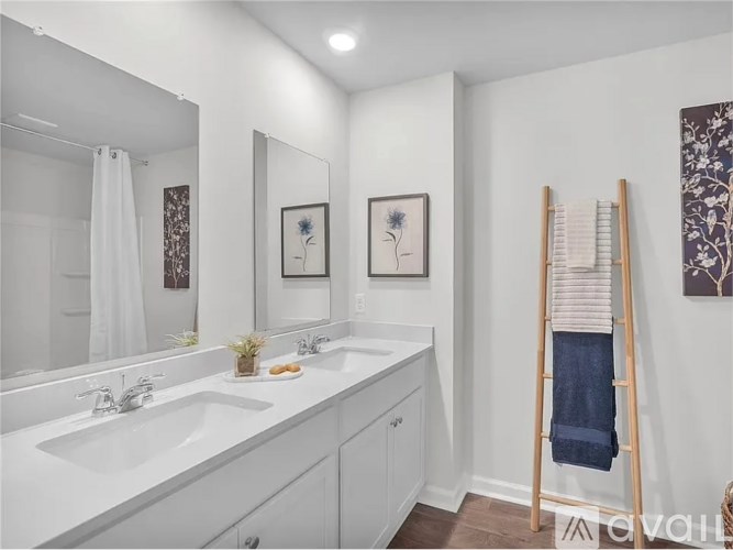 A bathroom with a white sink and a mirror.