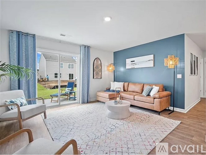 A living room with a brown leather couch and a white coffee table.