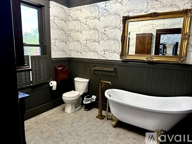 A bathroom with a claw foot tub and a toilet.