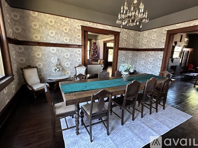A dining room with a wooden table and chairs.