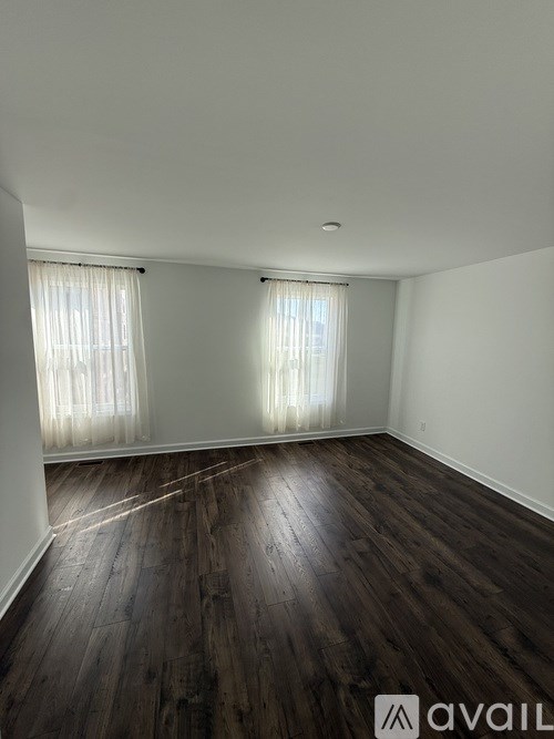 A room with wooden floors and white walls.