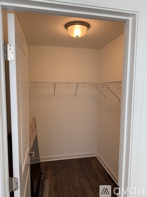 A small, empty closet with a light on.