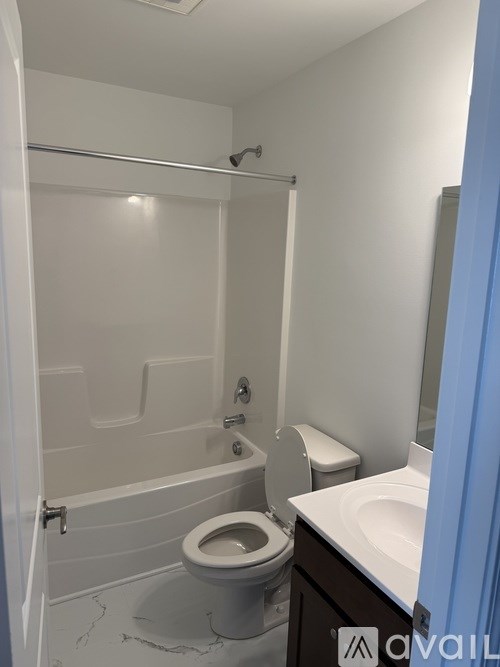 A white toilet in a bathroom with a glass shower door.