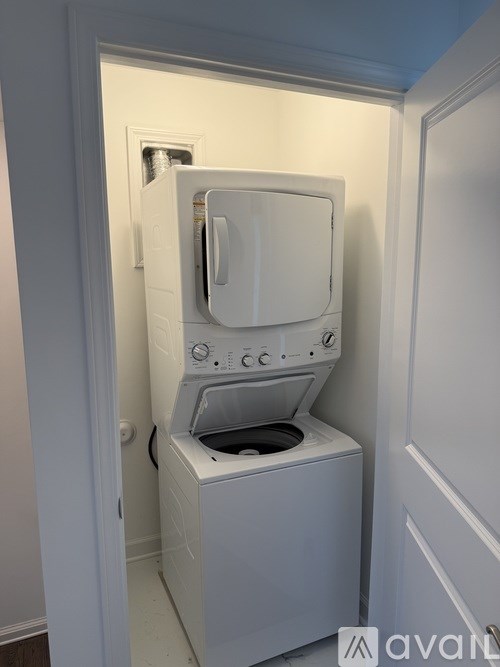 A white washing machine is in a small space.
