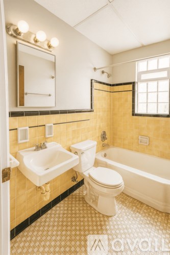 A bathroom with a sink, toilet and bathtub.